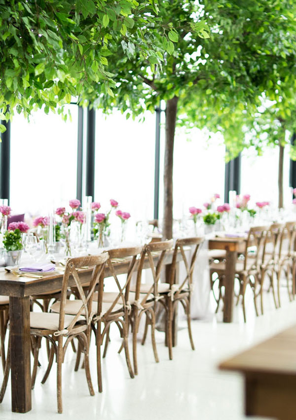 Isles of harvest tables and cross back wooden chairs