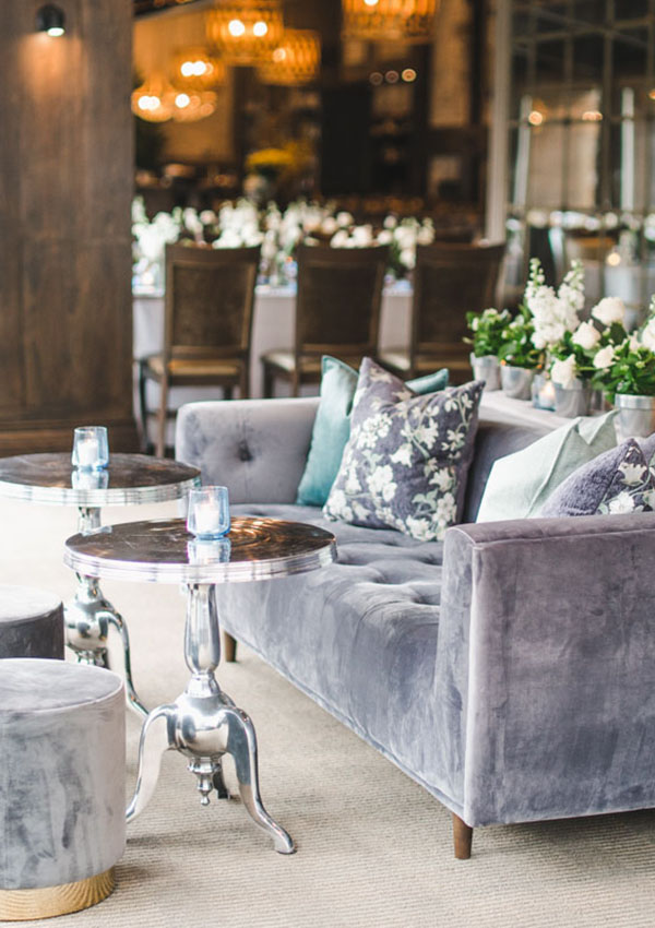 Velvet sofa and ottomans with chrome tables