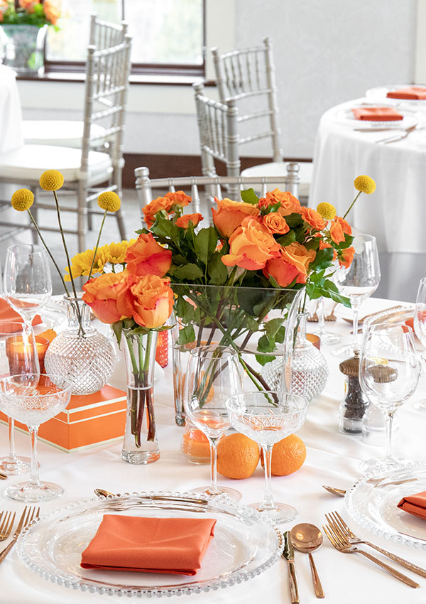 White table linens with orange accents